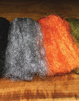 Sparkle Emerger Yarn by Hareline Dubbin, Inc with crinkly trilobal fiber in black, silver, orange, and olive for fly tying at Freestone Fly Shop