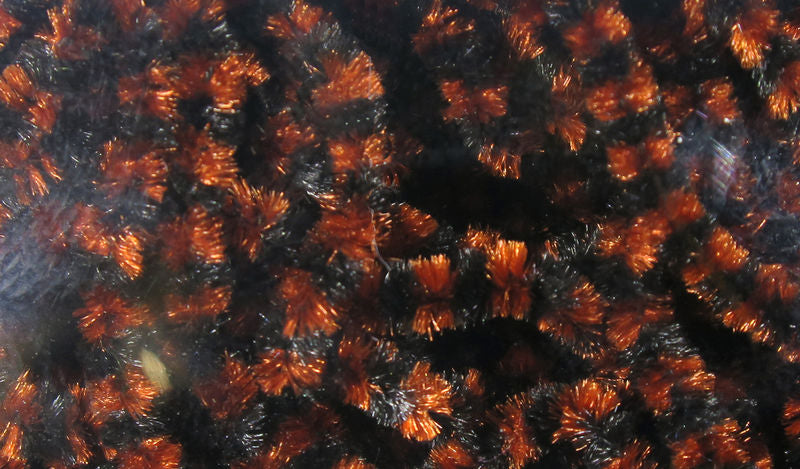 Small Varigated Chenille by Hareline Dubbin, Inc with rich orange and black fibers for fly tying at Freestone Fly Shop