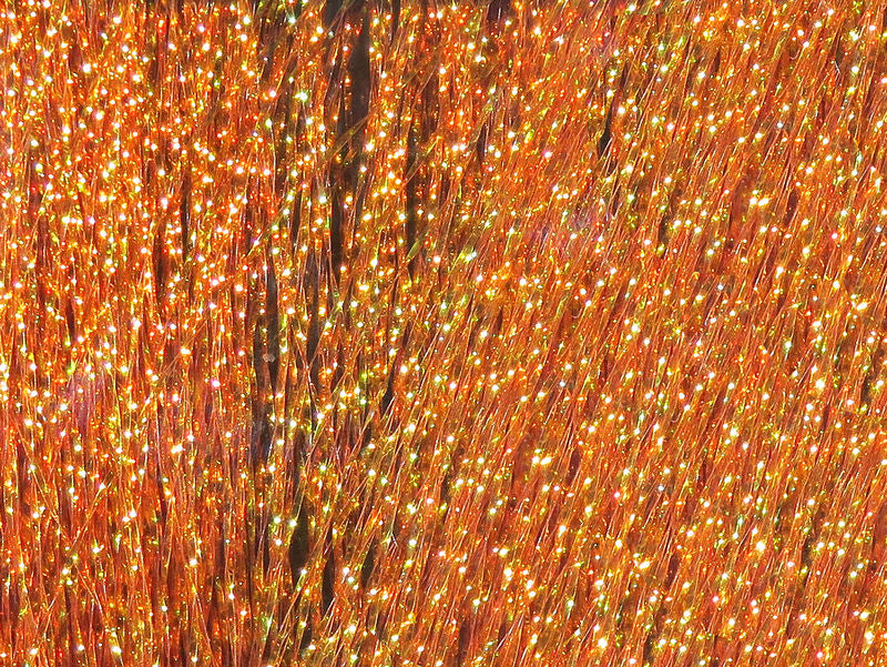 Krystal Flash in vivid orange hues with radiant sparkling strands by Hareline Dubbin, Inc for fly tying at Freestone Fly Shop