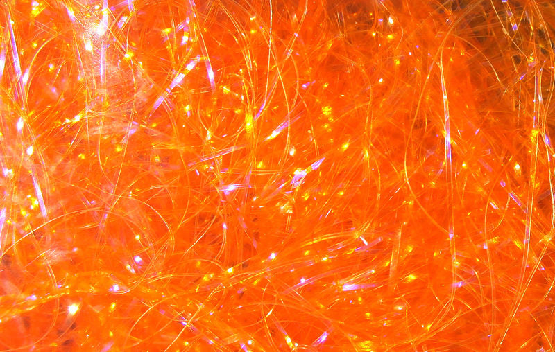 UV Polar Chenille fibers dyed in vibrant orange hues with subtle iridescence by Hareline Dubbin, Inc for fly tying
